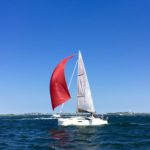 Sail boat with red spinnaker